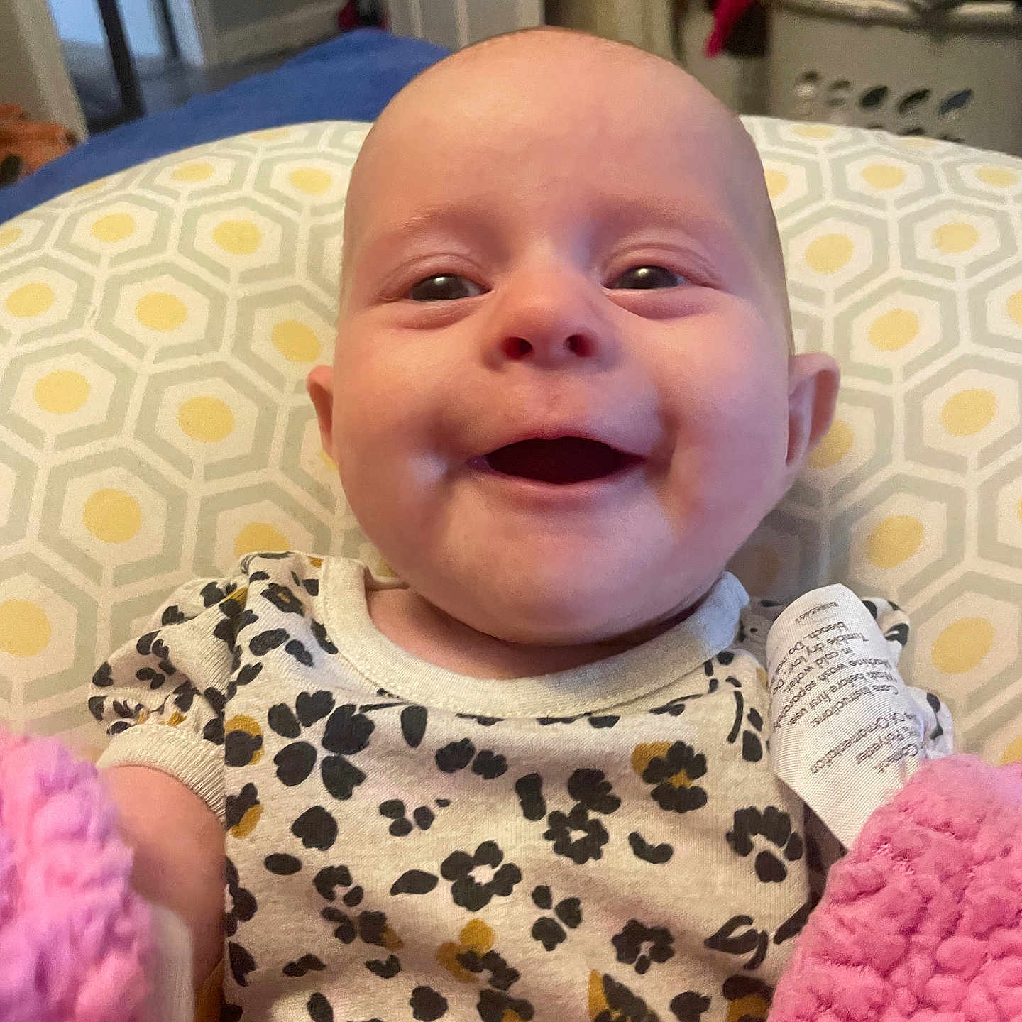 Eden-Pearl joined the competition — help win amazing prizes! baby, blanket, child, clothing, cozy, cute, face, floral, happy, home, indoors, infant, pattern, person, pillow, pink, portrait, smiling, soft, young
