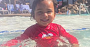 Thomas joined the competition — help win amazing prizes! blue_sky, child, daytime, elmo, fun, happy, hotel, lounge_chairs, outdoor, palm_trees, people, pool, red_shirt, smiling, splash, summer, sunny, swimming, vacation, water