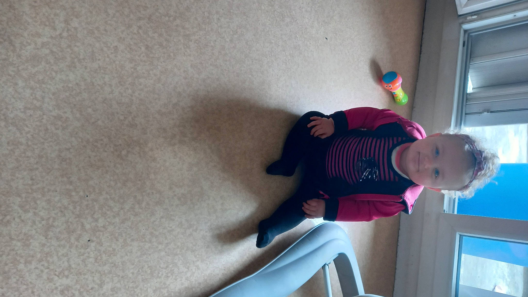 Théa participe au concours pour gagner de l'argent avec cette photo : baby_toddler_clothing, child, comfort, elbow, flooring, fun, hat, human_leg, knee, leg, magenta, person, room, sitting, sleeve, sock, t_shirt, thigh, toddler, window