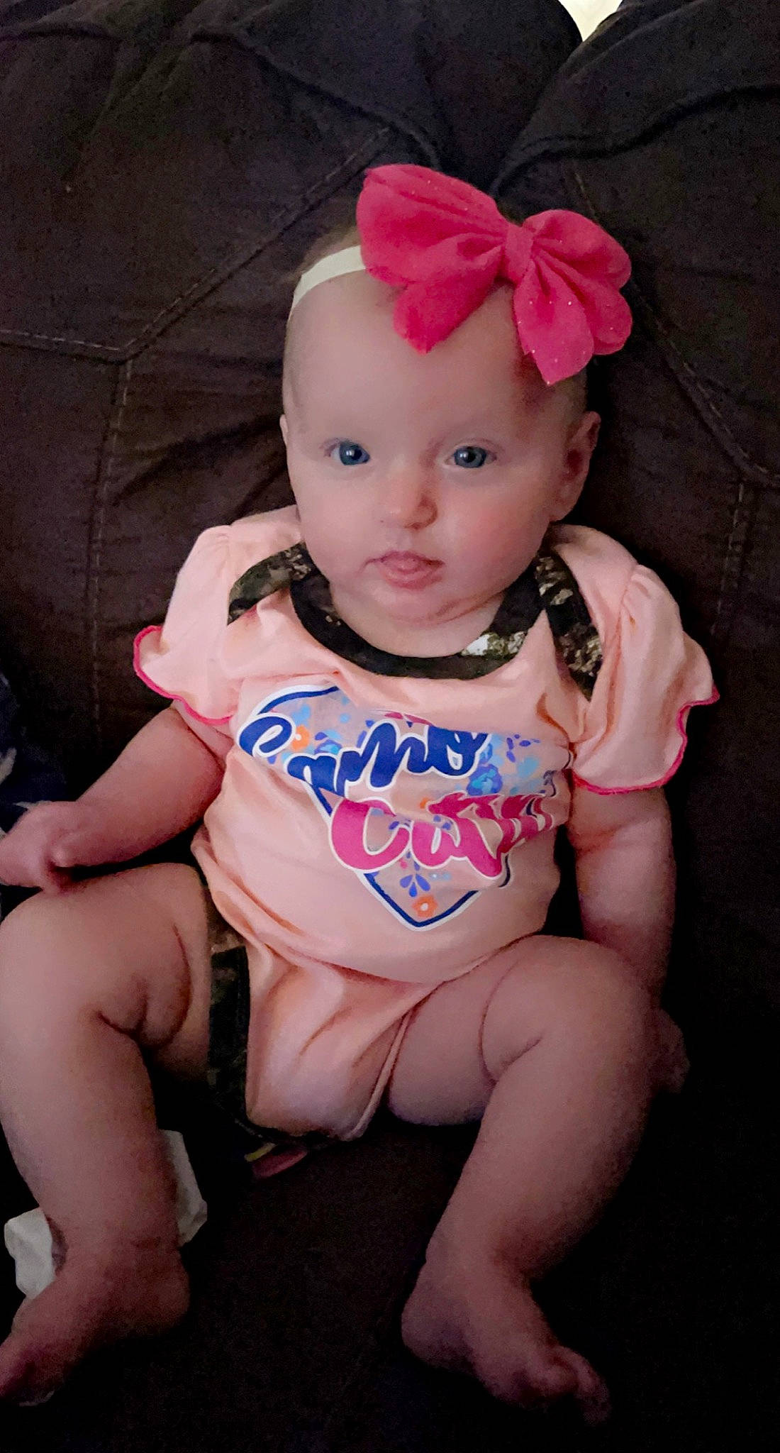 Mary Lee is registered to the contest to win money with this photo: baby, baby_products, baby_toddler_clothing, cheek, child, dress, eye, head, headband, headwear, human_leg, iris, knee, lip, pattern, person, pink, sitting, skin, sleeve