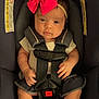 baby, infant, car_seat, bow, headband, straps, clothing, barefoot, child, seatbelt, cute, young, portrait, indoors, sitting, person, small_hands, legs, face, safety