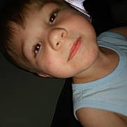 Thomas is registered to the contest to win money with this photo: child, face, red_eye, indoor, person, close_up, tshirt, sleeveless, skin, young, portrait, casual, expressionless, head, hair, light_blue, human, childhood, young_child, person_closeup