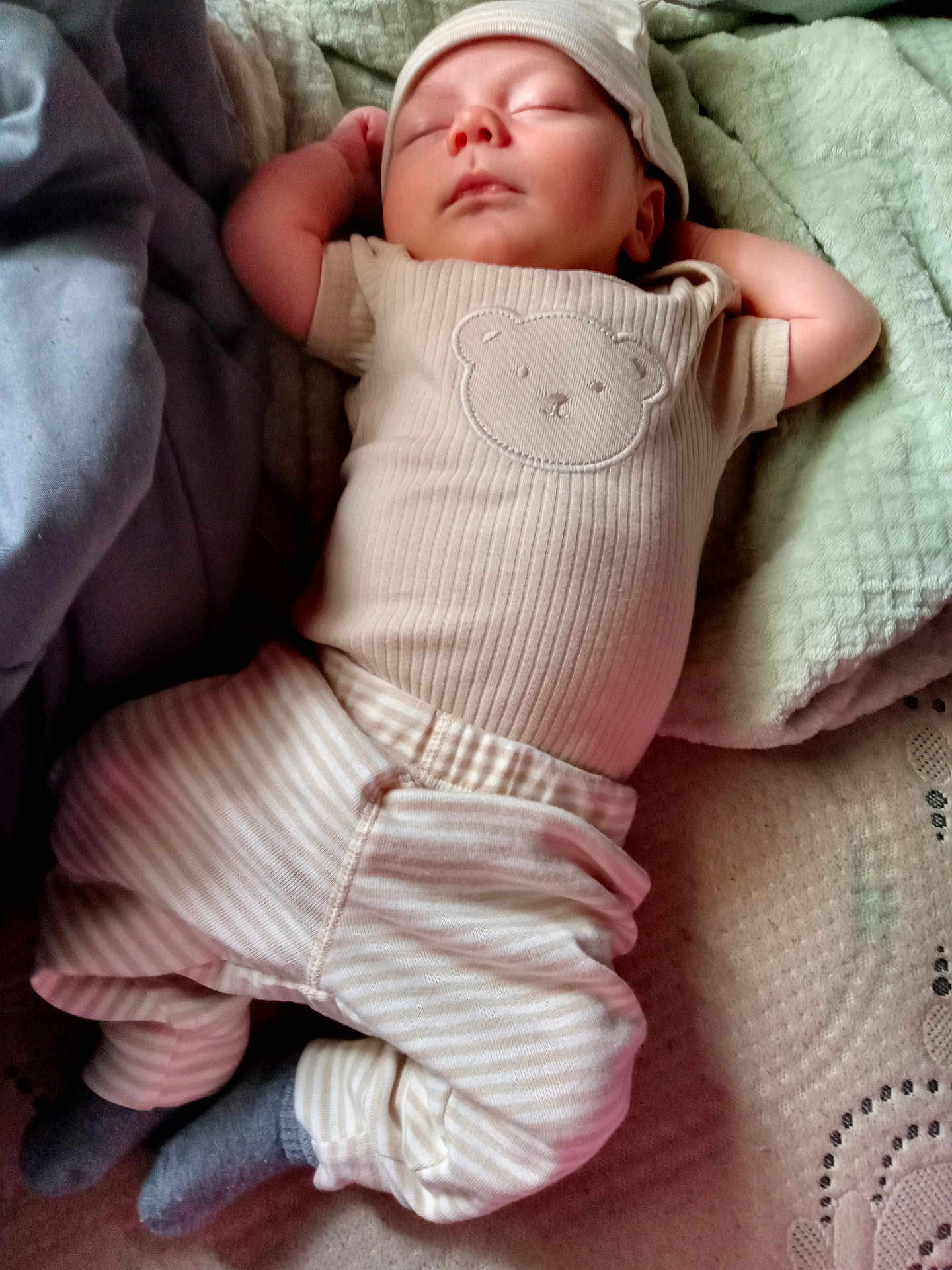 Xavier is registered to the contest to win money with this photo: baby, sleeping, infant, blanket, clothing, cute, face, headwear, pajamas, sock, soft, resting, peaceful, child, portrait, indoor, comfort, newborn, cozy, nap