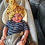 baby, giraffe_hat, striped_clothing, smile, cushion, baby_seat, stuffed_toy, happy, child, indoor, cute, infant, portrait, comfort, playful, blue, soft_toy, seat_belt, relaxed, cheerful