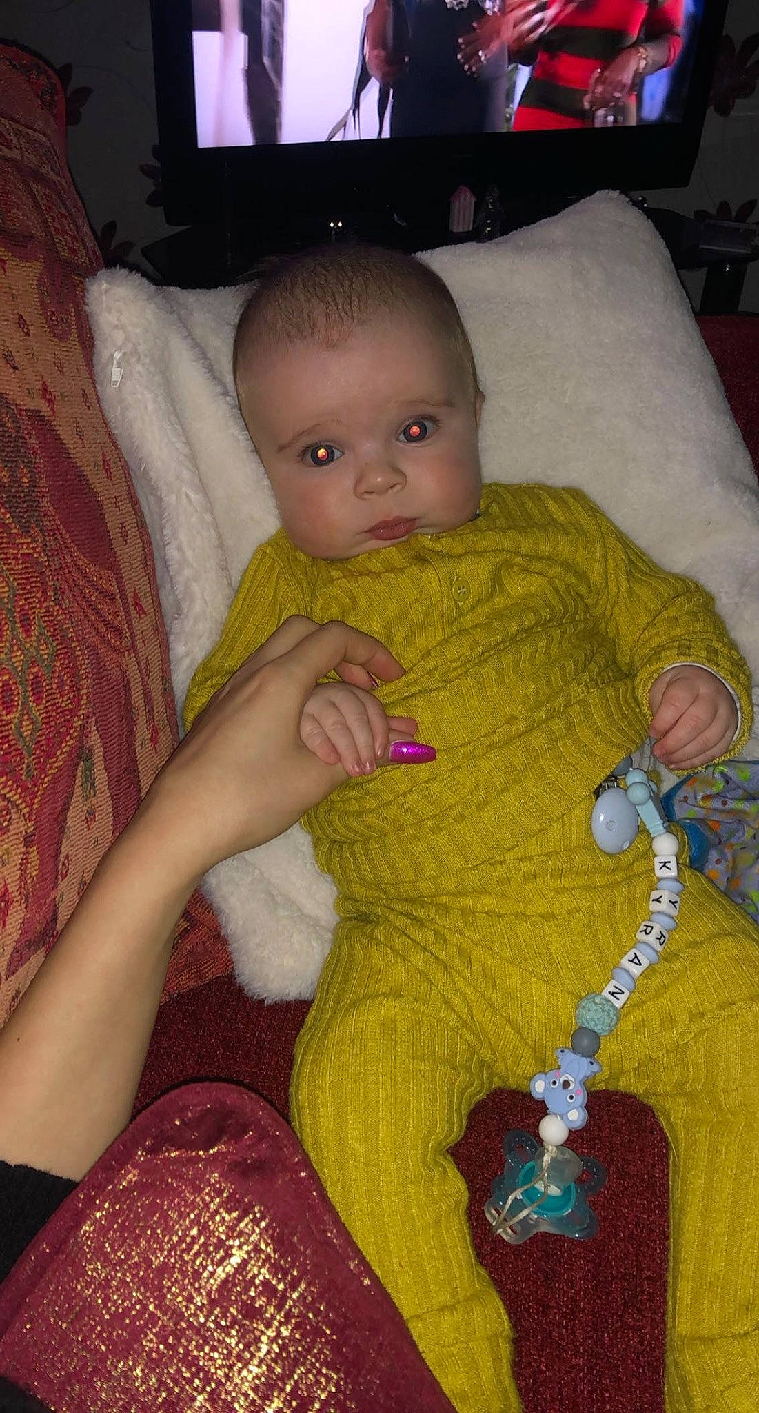 Kyran joined the competition — help win amazing prizes! arm, baby, baby_toddler_clothing, chair, cheek, child, comfort, eye, facial_expression, hand, head, human_body, iris, jewellery, lap, linens, pattern, person, sitting, toddler