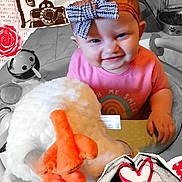 Jubilee is registered to the contest to win money with this photo: baby, child, smiling, bow, headband, pink_shirt, plush_toy, stuffed_animal, orange, white, indoor, floor, toy, hands, face, person, vintage_telephone, collage, heart, rose