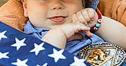 Yovani joined the competition — help win amazing prizes! baby, cowboy_hat, bracelet, american_flag, basket, belt_buckle, blue_shirt, smile, face, hand, outdoor, cute, portrait, infant, happy, child, closeup, hat, person, fashion