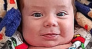 Yovani is registered to the contest to win money with this photo: baby, blanket, child, clothing, colorful, cozy, cute, expression, eyes, face, happy, head, indoor, infant, person, portrait, sitting, smile, superhero, young