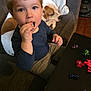 Rexton joined the competition — help win amazing prizes! toddler, child, dog, couch, toy, table, indoor, curious, snack, figurines, sleeping, brown_hair, blue_shirt, gray_pants, wooden_floor, cozy, playful, pet, person, young_child