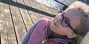 Eleanore participe au concours pour gagner de l'argent avec cette photo : accessories, architecture, boardwalk, bridge, building, child, face, female, girl, glasses, head, house, person, photography, pier, port, portrait, water, waterfront, wood