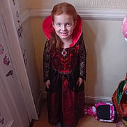 River joined the competition — help win amazing prizes! child, girl, costume, vampire, halloween, smile, indoor, floor, hoverboard, wall, door, decorations, red_hair, long_hair, black_lace, red_dress, socks, toy, happy, portrait