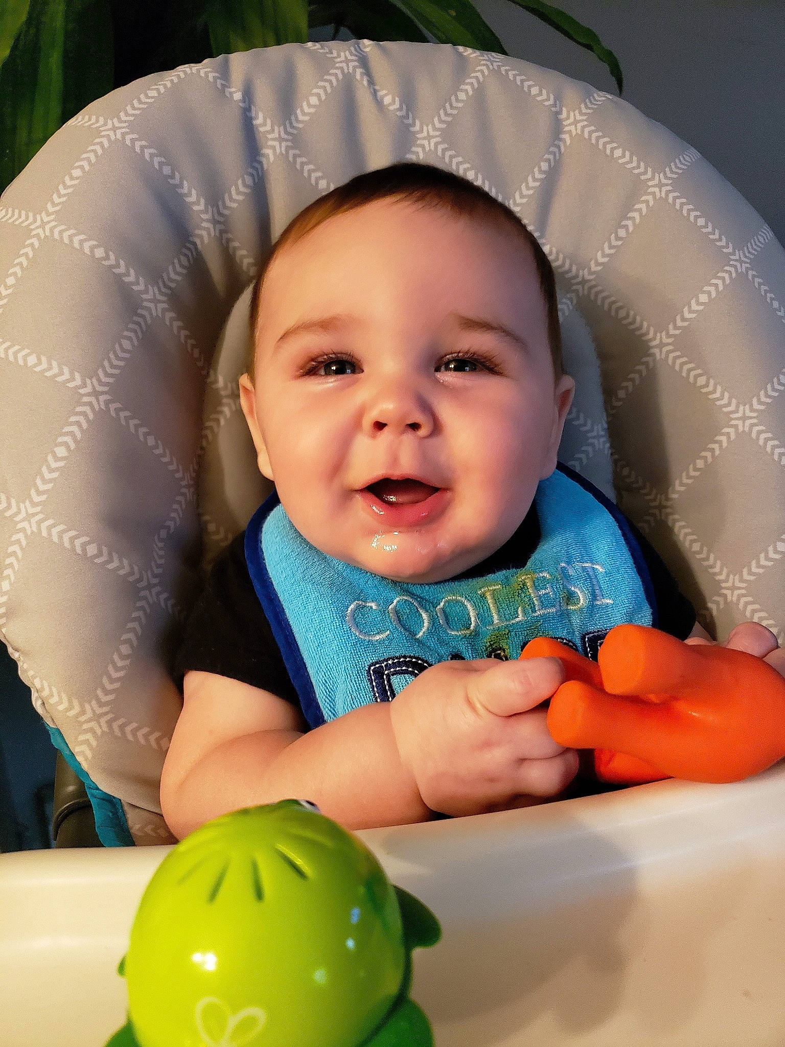 Tommy is registered to the contest to win money with this photo: baby, cheek, child, eye, face, facial_expression, finger, fun, green, hand, head, mouth, nose, person, play, skin, smile, toddler