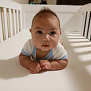 Ryker is registered to the contest to win money with this photo: baby, bed, bodypart, crawling, crib, face, finger, furniture, hand, hardwood, head, indoors, infantbed, newborn, nursery, person, photography, portrait, room, wood