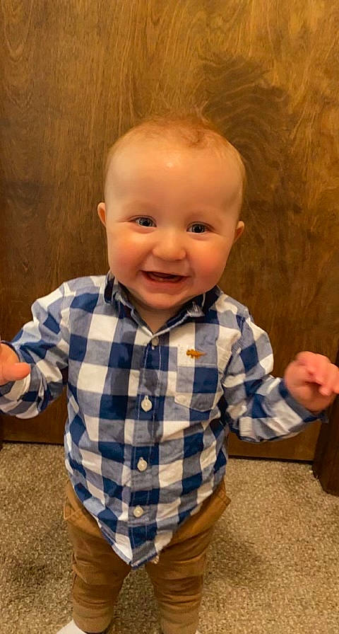 Mavryck is registered to the contest to win money with this photo: baby, baby_toddler_clothing, cheek, child, chin, dress_shirt, eye, flooring, fun, gesture, happy, iris, nose, pattern, person, skin, sleeve, smile, thumb, toddler