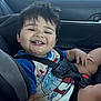 Arsenio joined the competition — help win amazing prizes! toddler, child, car_seat, car_interior, smiling, happy, seatbelt, shorts, hair, face, window, daylight, casual_clothing, spiderman, sitting, cute, baby, car, person, interior