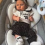 baby, infant, polka_dot, clothing, headband, socks, baby_rocker, plush_toy, face, person, cute, indoor, child, newborn, seat, comfort, expression, white, black, soft_furniture