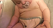 River is registered to the contest to win money with this photo: baby, blanket, child, comfort, cushion, cute, diaper, giraffe_pattern, hair, hand, indoor, leg, nap, pacifier, peaceful, rest, seat, skin, sleeping, toddler