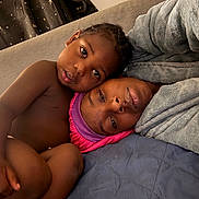 Daemari is registered to the contest to win money with this photo: child, adult, bed, blanket, cozy, intimate, portrait, face, skin, person, indoor, curtain, fabric, headwear, comfort, family, closeup, relaxation, candid, love