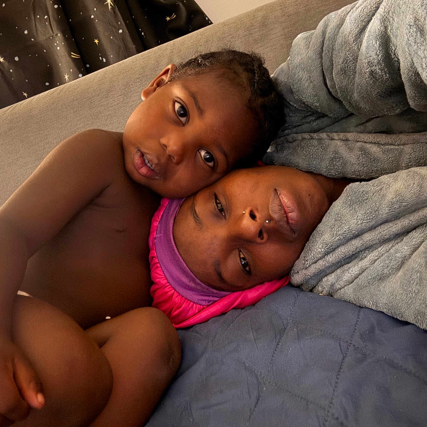 Daemari is registered to the contest to win money with this photo: child, adult, bed, blanket, cozy, intimate, portrait, face, skin, person, indoor, curtain, fabric, headwear, comfort, family, closeup, relaxation, candid, love