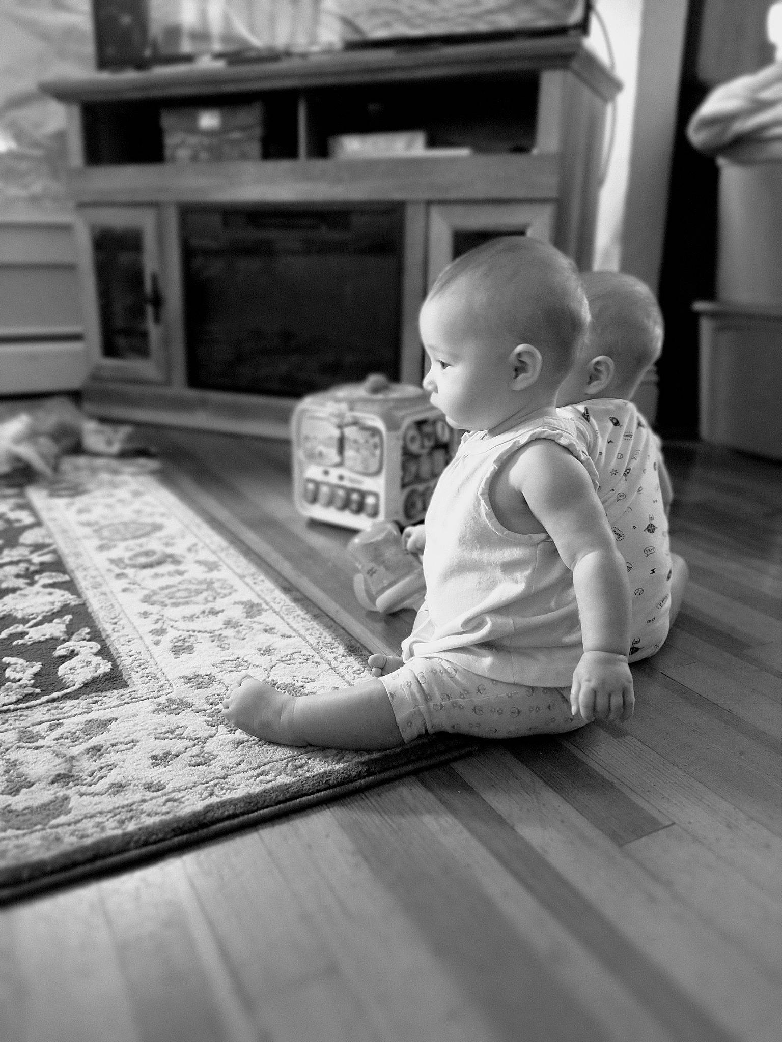 Xariyah joined the competition — help win amazing prizes! baby, black_and_white, child, floor, flooring, home, monochrome, person, photograph, photography, play, room, sitting, snapshot, standing, stock_photography, toddler, toy, white, wood