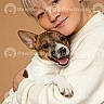 affection, animal, close_up, cute, dog, ears, face, friendly, happy, hugging, human, indoor, love, pet, portrait, small_dog, smiling, warm_background, white_sweater, woman