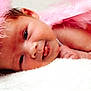 adorable, baby, baby_clothing, child, closeup, cozy, cute, face, feathers, happy, headband, infant, lying_down, newborn, pink, portrait, skin, smile, soft, tongue