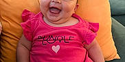 Zara joined the competition — help win amazing prizes! baby, child, chubby, couch, cute, face, furniture, happy, head, indoor, infant, living_room, person, pillows, pink_onesie, plump, seated, skin, smiling, tongue