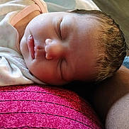 Royalty is registered to the contest to win money with this photo: baby, newborn, sleeping, face, head, skin, hair, person, arm, clothing, texture, closeup, peaceful, rest, infant, portrait, soft_light, indoors, cuddle, pink