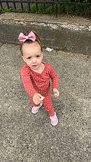 Zavira is registered to the contest to win money with this photo: asphalt, baby, baby_toddler_clothing, child, clothing, flooring, fun, grass, happy, person, play, road_surface, sitting, sleeve, smile, soil, toddler, wood