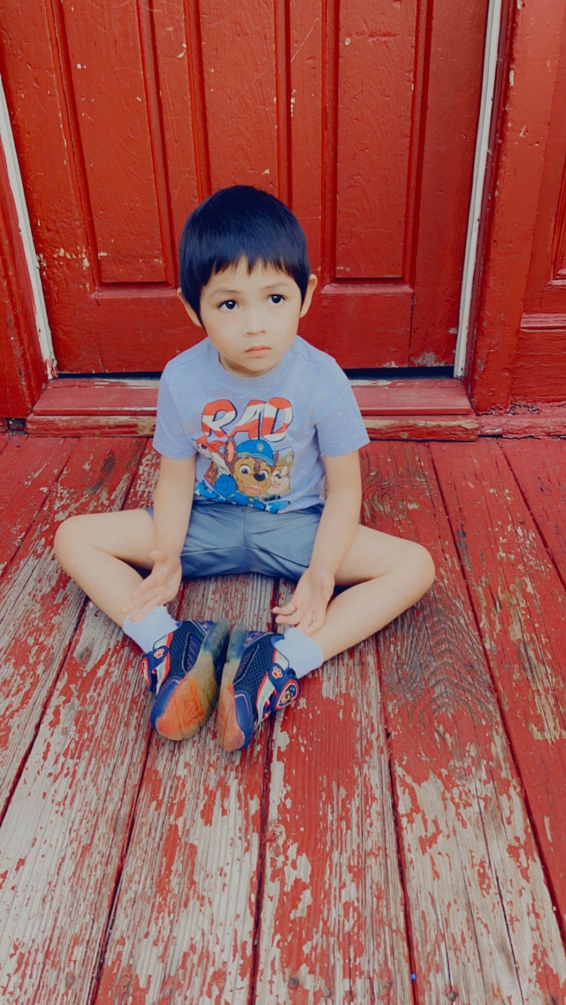 Ziren King is registered to the contest to win money with this photo: baby_toddler_clothing, child, door, electric_blue, flooring, fun, happy, hardwood, human_leg, joint, orange, person, pink, red, shoulder, sitting, skin, standing, thigh, toddler