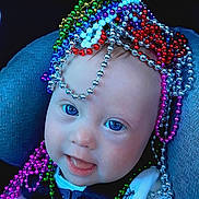 Adalee is registered to the contest to win money with this photo: baby, child, blue_eyes, beads, colorful, mardi_gras, car_seat, smiling, face, closeup, infant, cute, playful, necklace, happy, portrait, clothing, seatbelt, headwear, accessories