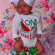 Cynturi is registered to the contest to win money with this photo: baby, sleeping, onesie, bow, ribbons, watermelon, floral_blanket, infant, cute, peaceful, clothing, feet, headwear, pattern, fabric, child, portrait, soft, resting, adorable