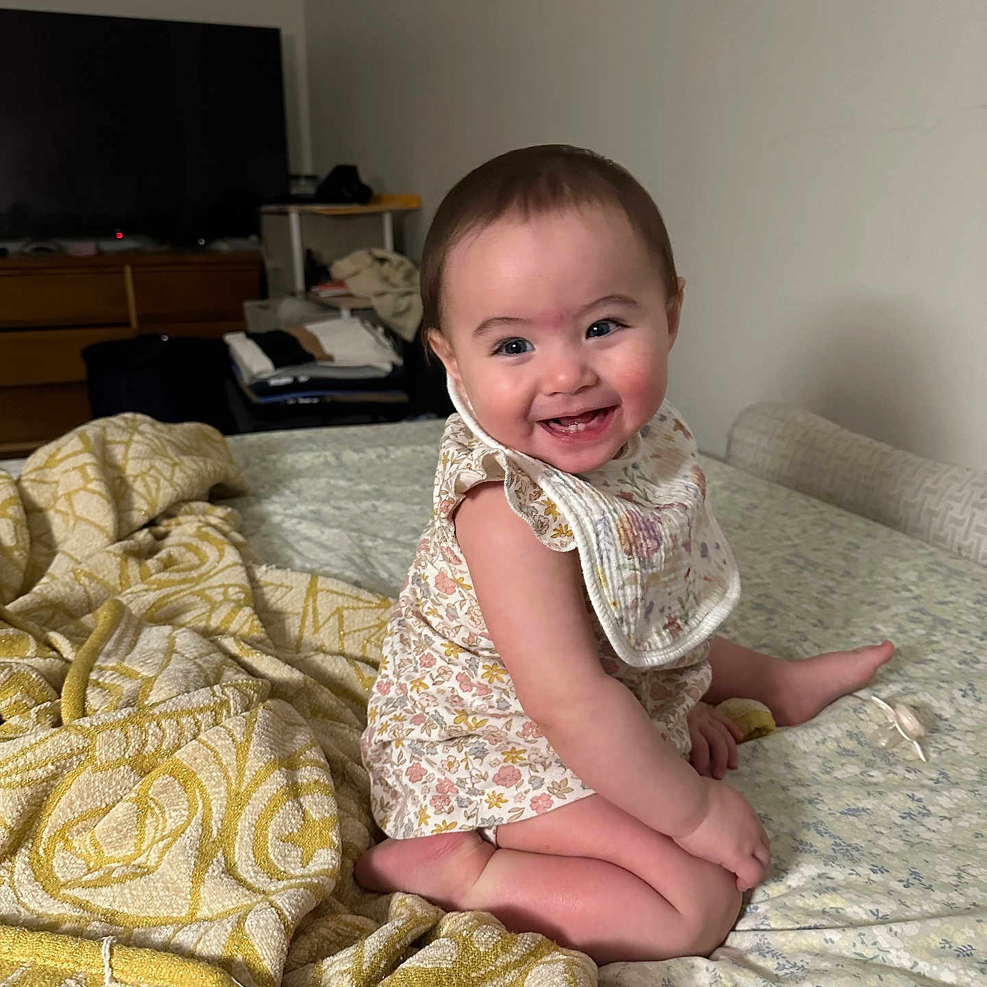 Eleanor Grey Balanza joined the competition — help win amazing prizes! baby, bed, bib, blanket, child, cute, face, furniture, happy, home, indoor, infant, onesie, person, room, sitting, skin, smiling, television, young