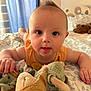 Elio participe au concours pour gagner de l'argent avec cette photo : baby, infant, child, plush_toy, bedspread, pattern, curtains, bedroom, toy, hand, face, eyes, orange_clothing, soft_toy, indoor, light, moawk_hair, person, closeup, crawling