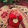 baby, infant, child, christmas, holiday, blanket, christmas_tree, string_lights, headband, red_clothing, santa_print, striped_pants, cozy, festive, portrait, lying_down, indoors, gaze, soft_texture, bedding