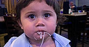 Victor joined the competition — help win amazing prizes! toddler, child, spaghetti, food, restaurant, blue_lighting, indoor, person, curly_hair, shirt, dining, seat, table, face, expression, large_eyes, messy, cute, young, portrait