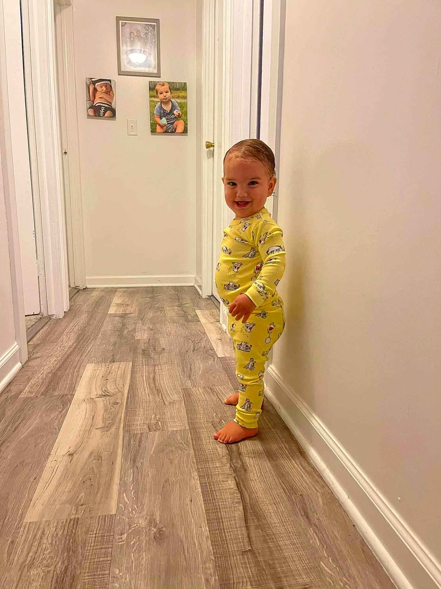 Carter is registered to the contest to win money with this photo: baby, baby_toddler_clothing, door, fashion_design, floor, flooring, fun, hardwood, home_door, human_leg, joy, laminate_flooring, leg, pattern, person, sleeve, smile, toddler, varnish, wood