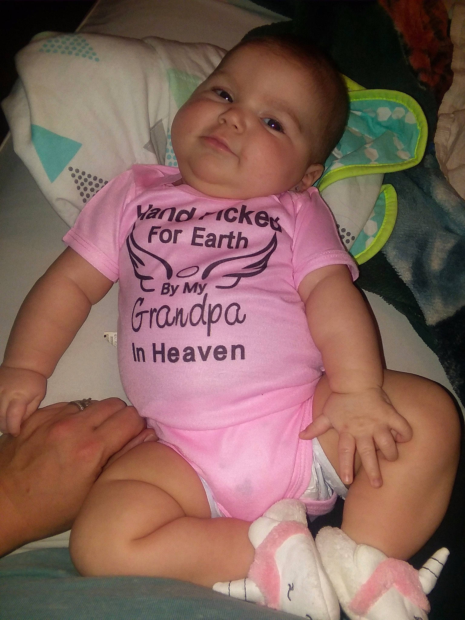 Charly is registered to the contest to win money with this photo: abdomen, arm, cheek, child, day, eye, face, finger, girl, hand, head, human_hair_color, infant, leg, person, pink, product, sitting, skin, toddler