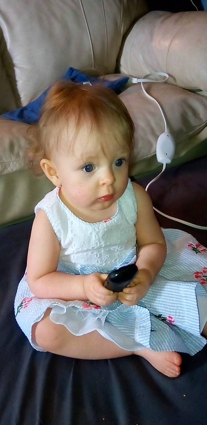 Lavina is registered to the contest to win money with this photo: baby, baby_products, baby_toddler_clothing, beauty, blue, cheek, child, comfort, facial_expression, fun, happy, iris, lap, pattern, person, pink, sitting, skin, sock, toddler