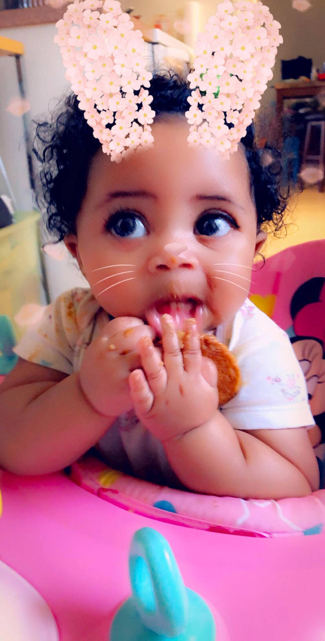 Amora is registered to the contest to win money with this photo: baby, cheek, child, eating, eye, eyebrow, face, finger, hair_accessory, head, headband, headgear, lip, mouth, nail, nose, person, pink, skin, surprise