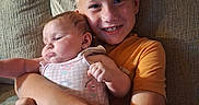 Ava is registered to the contest to win money with this photo: baby, child, couch, family, infant, indoor, love, older_brother, person, portrait, sitting, smiling, toddler, togetherness, young_child, cuddling, arm, clothing, face, home