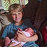 Ava is registered to the contest to win money with this photo: child, baby, newborn, boy, smiling, indoor, couch, holding, family, portrait, window, natural_light, clothing, blanket, home, cute, infant, person, happy, casual