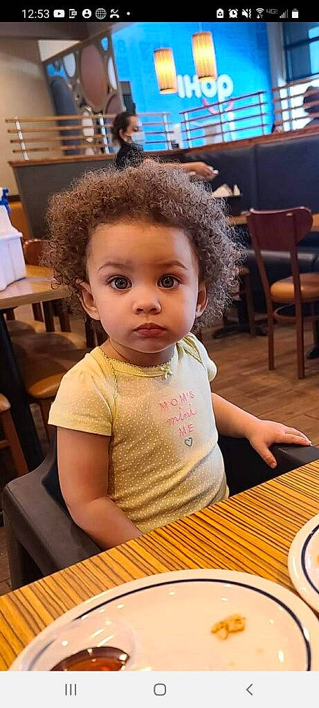 Arissa is registered to the contest to win money with this photo: beauty, chair, cheek, child, chin, dishware, eyelash, flooring, fun, furniture, hairstyle, person, plate, serveware, skin, t_shirt, table, tableware, toddler, varnish