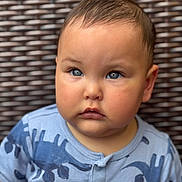 Dylan joined the competition — help win amazing prizes! baby, blue_eyes, casual_clothing, child, chubby_cheeks, closeup, curious, cute, dinosaur_print, expression, face, indoor, infant, onesie, portrait, short_hair, sitting, soft_lighting, wicker_background, young_child