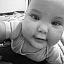 Dylan is registered to the contest to win money with this photo: baby, infant, face, close_up, black_and_white, smile, eyes, skin, cute, child, person, portrait, young, indoors, apparel, shirt, crawling, expression, soft, adorable