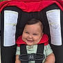 Dylan joined the competition — help win amazing prizes! baby, smiling, stroller, red, black, outdoor, sidewalk, child, happy, straps, infant, cute, person, seat, green, shorts, shirt, hands, face, babywearing