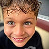 child, boy, smile, face, wet_hair, eyes, portrait, happy, close_up, casual_clothing, young, cute, innocent, person, outdoor, expression, head, skin, cheeks, joyful