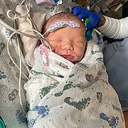 Khristopher joined the competition — help win amazing prizes! newborn, baby, hospital, blanket, footprints, swaddled, medical, infant, sleeping, face, person, gloved_hand, equipment, bed, healthcare, pediatric, cute, tiny, patient, nursery