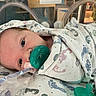 Khristopher joined the competition — help win amazing prizes! newborn, baby, pacifier, hospital, bassinet, blanket, footprint_pattern, infant, swaddled, medical, patient, sleeping, cute, child, face, lying_down, indoors, healthcare, hospital_room, closeup