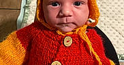 Khristopher joined the competition — help win amazing prizes! baby, infant, knitted_clothing, hat, yellow, red, cute, portrait, child, face, button, handmade, warm, cozy, newborn, milestone, 1_month, indoors, person, soft